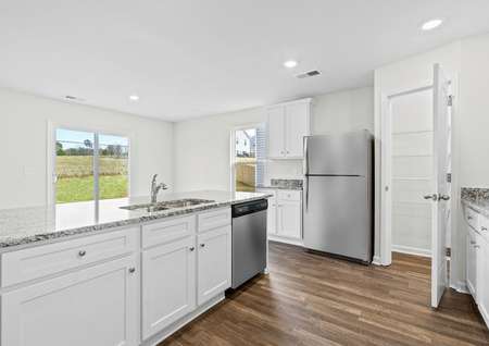 Large kitchen with stainless steel appliances and granite countertops.