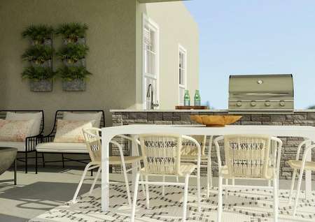 Rendering of back patio with outdoor
  furniture and table in front of a built in gas grill and sink.