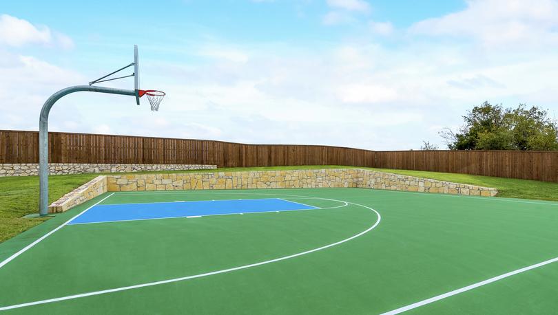 Outdoor basketball court with a green court.