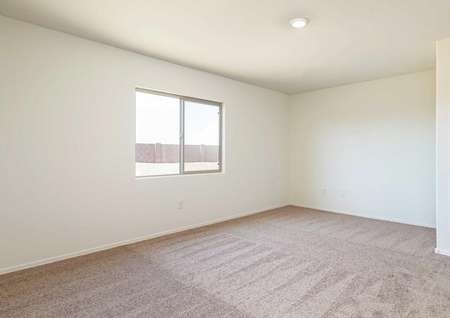 The Roosevelt floor plan master bedroom shown spacious carpeted bedroom with a single window.