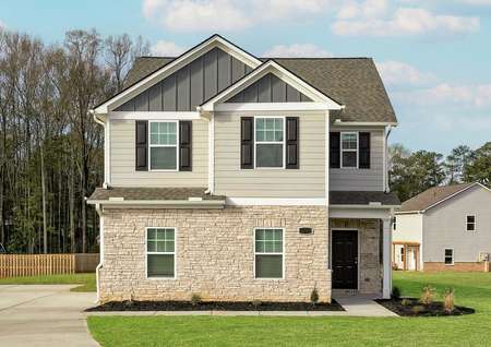 Beautiful two-story home with front yard landscaping and side-entry garage