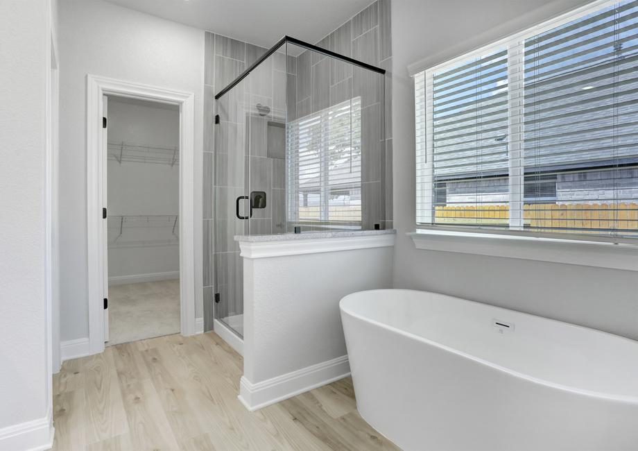 Master bathroom with a large walk-in shower and separate soaking tub.