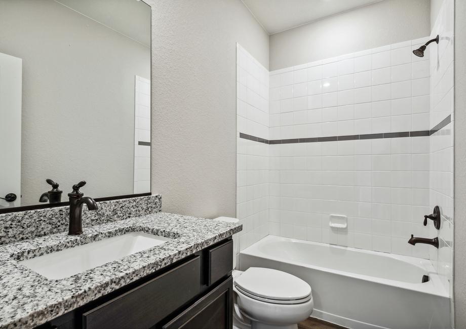 Secondary bathroom with a dual shower and tub.
