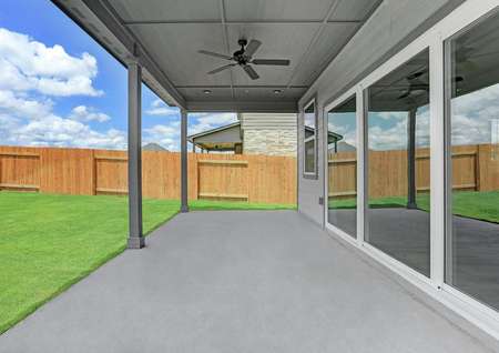 Covered back patio with direct access to the living room through the large sliding glass doors.
