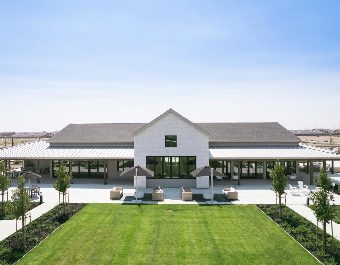 The Ranch House at Club Liberty with several sitting areas and greenery.