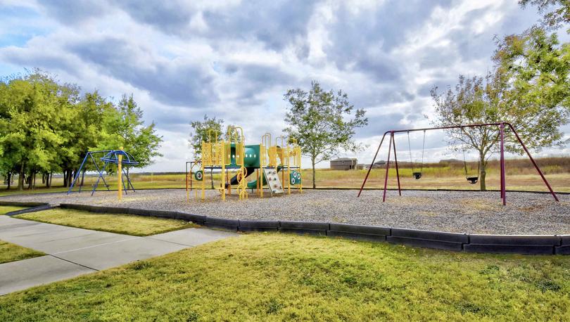 Bunton Creek new home community park with swing set, jungle gym, and walking paths