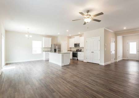 Avery great room with wood floors, chandelier, and white-finish kitchen