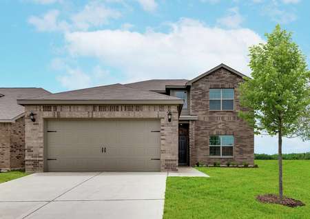 The Oakmont has a beautiful brick exterior and lush front yard landscaping.