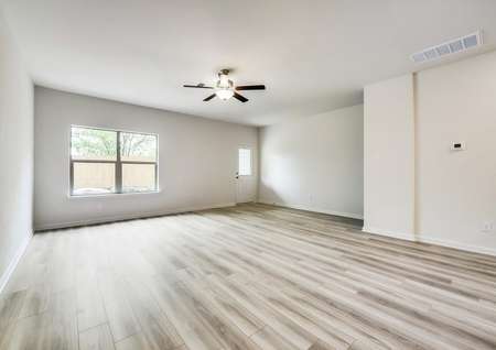 A wide family room offering great lighting and luxury vinyl plank flooring.